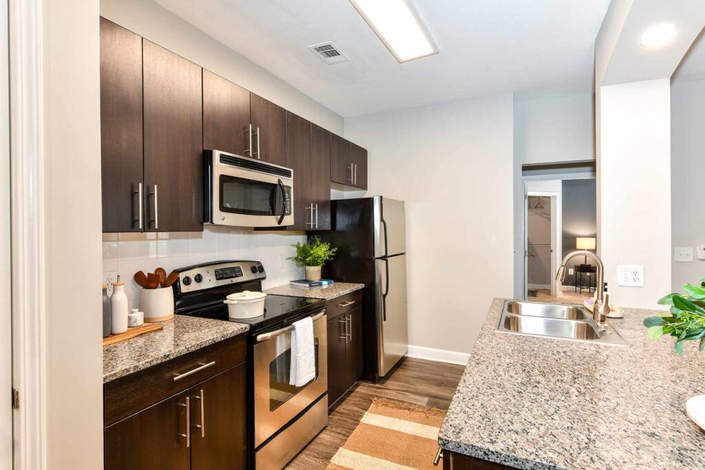 Kitchen with granite countertops, stainless steel appliances, and tile backsplash