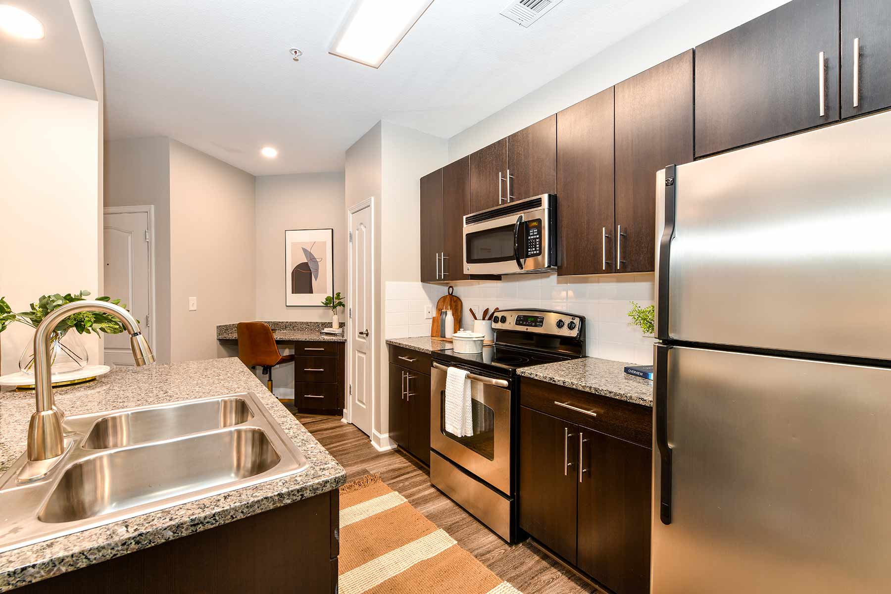 Kitchen with granite countertops, stainless steel appliances, and tile backsplash