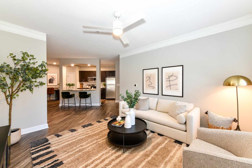 Staged living room wit view of the kitchen over the breakfast bar seating