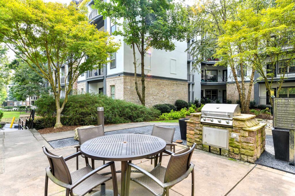 Courtyard with outdoor kitchen, grill and table seating