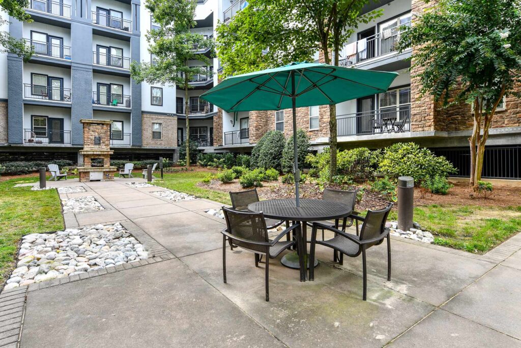 outdoor courtyard with fire pit, tables and chairs