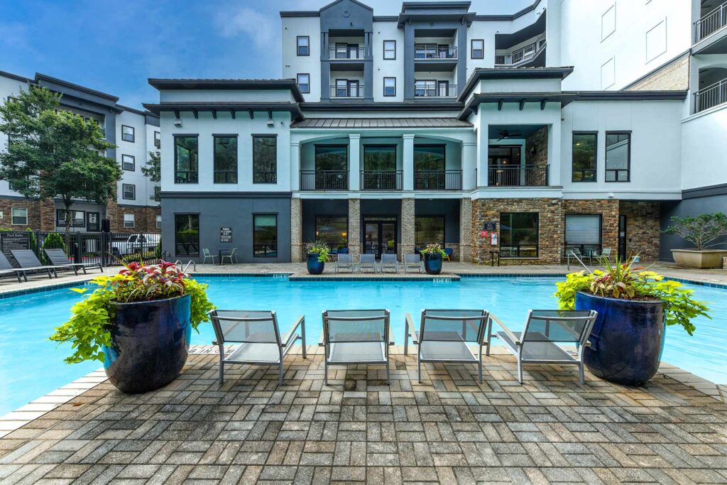 Pool with deck seating next to the clubhouse