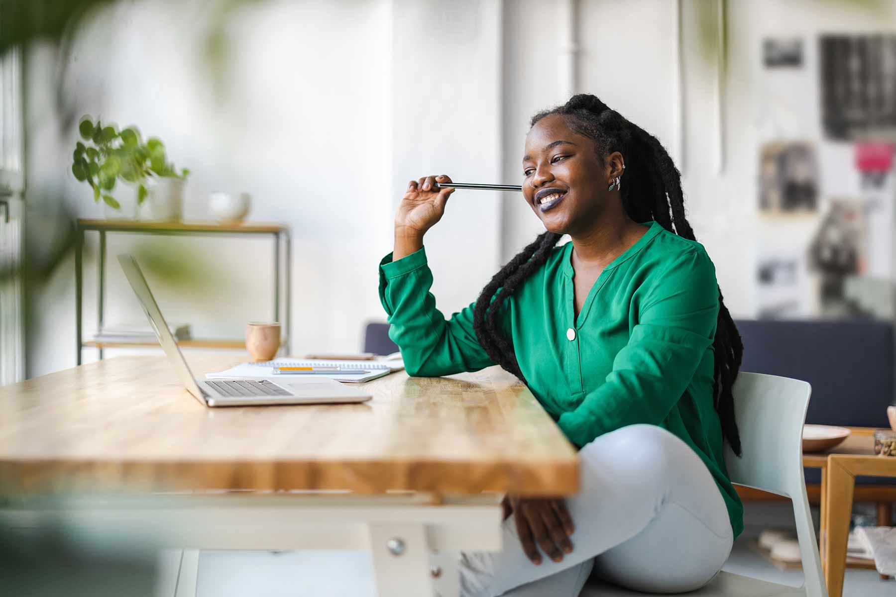 Young woman working at a table with a laptop